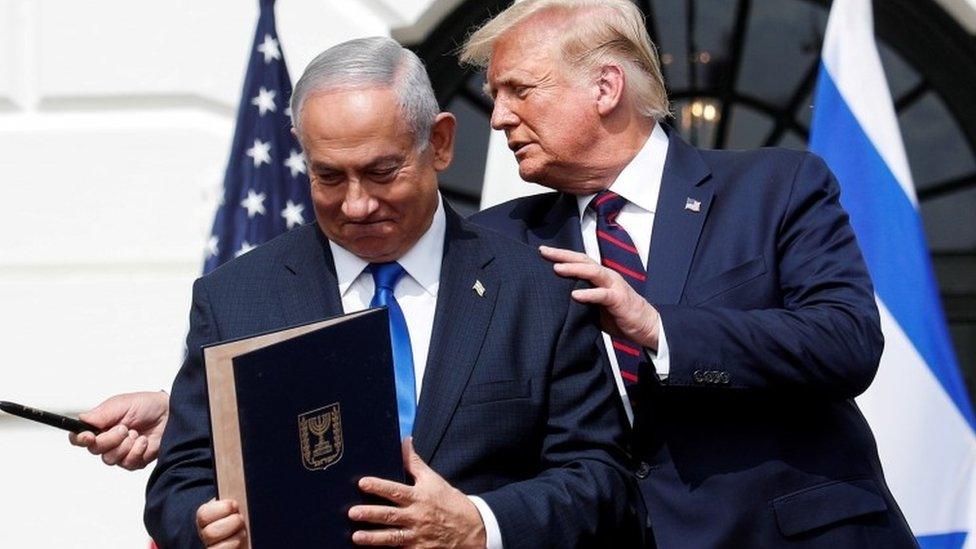 Benjamin Netanyahu stands with US President Donald Trump after signing the Abraham Accords with three Middle East states on the South Lawn of the White House (15 September 2020)