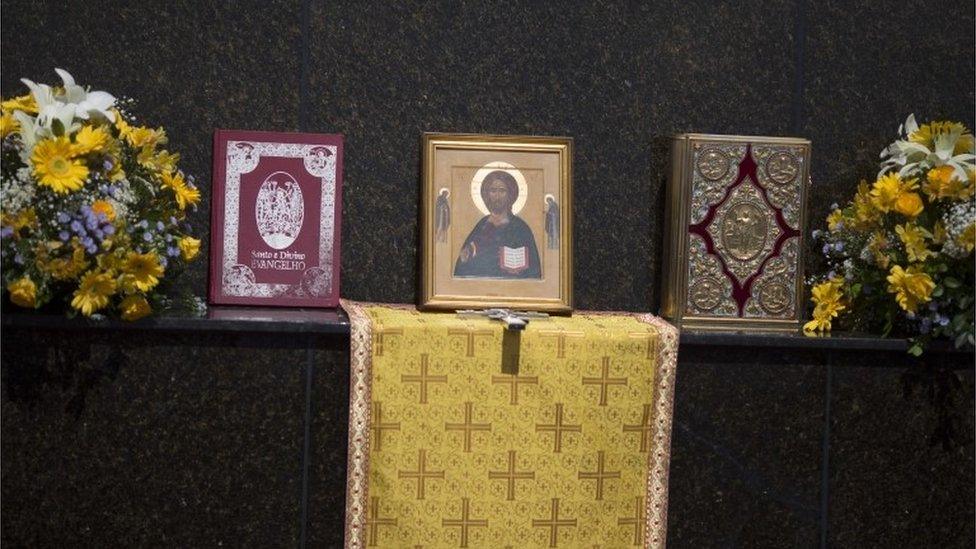 Christian symbols are displayed before the Russian Orthodox Church Patriarch Kirill as he gives a religious service in front of the Christ the Redeemer statue