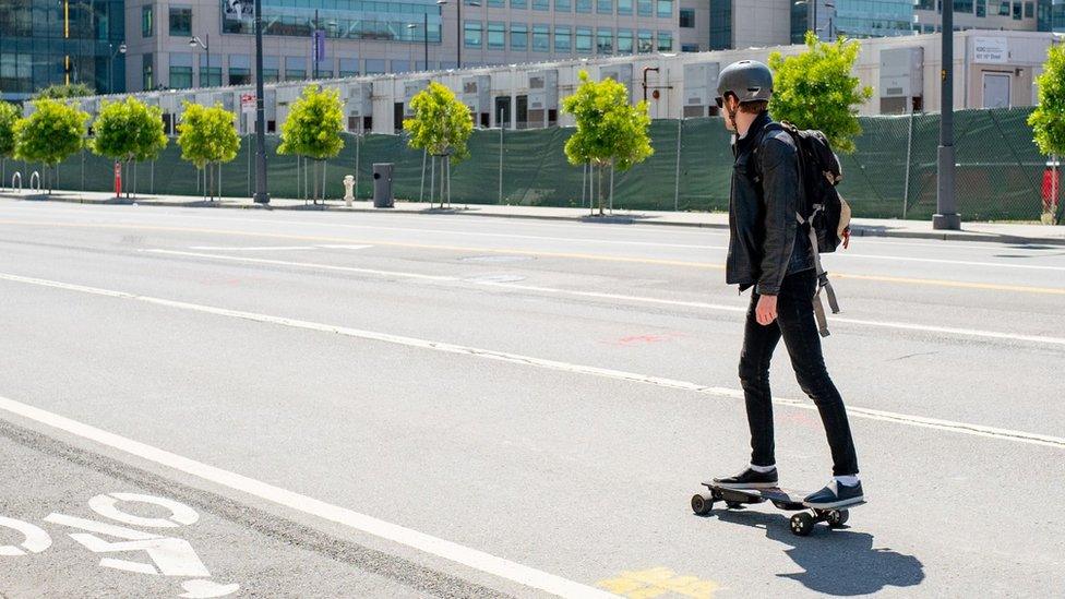 Man on electric skateboard