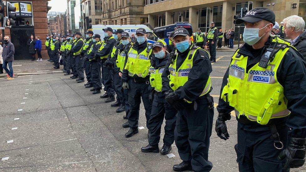 A line of police in a cordon during a climate protest in Glasgow