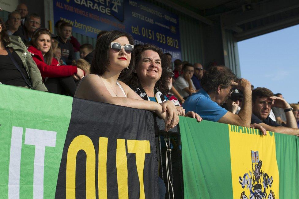 Home supporters watching the second-half action at the Mersey Travel Arena