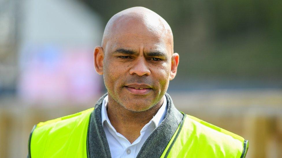 Bristol Mayor Marvin Rees standing outside wearing a high-vis jacket over his clothes