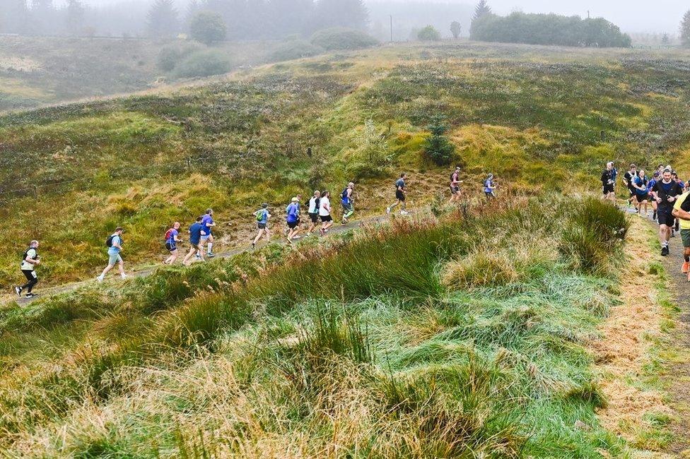 People running up a hill