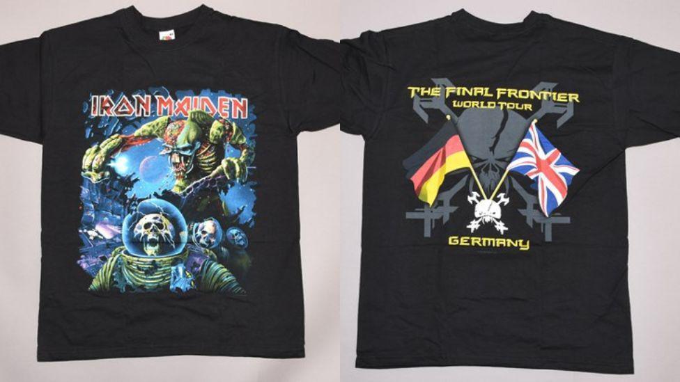 A composite image of the front and back of an Iron Maiden t-shirt. The t-shirt is black. The front has a skull inside a spacesuit being chased by a large green alien and the words 'Iron Maiden' in large red writing above it. The back has the words 'The final frontier world tour Germany' around a white skull motif with the German and British flags coming out the top.