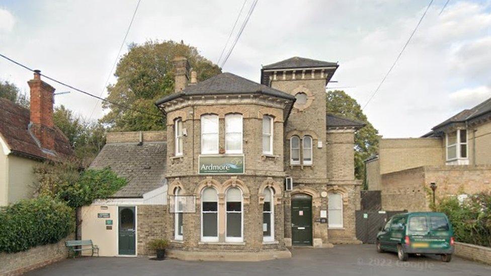 Two-storey stone building with hexagonal roof on front elevation