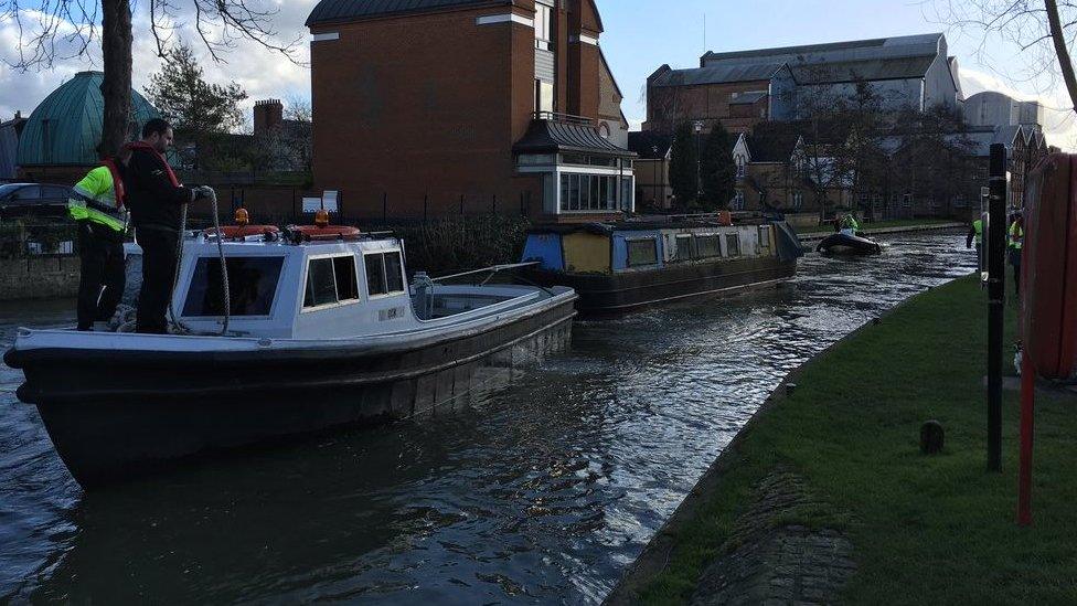 One of the boats being towed