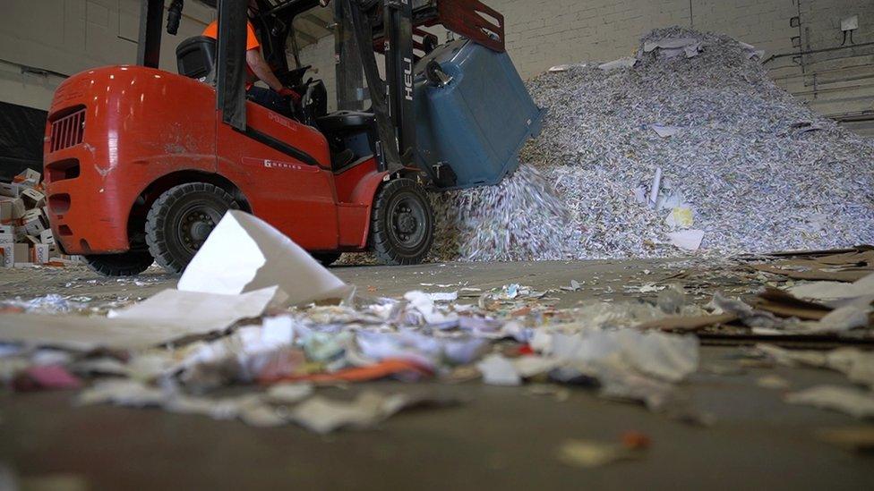 The bags are shredded and baled up before being sent off to paper mills