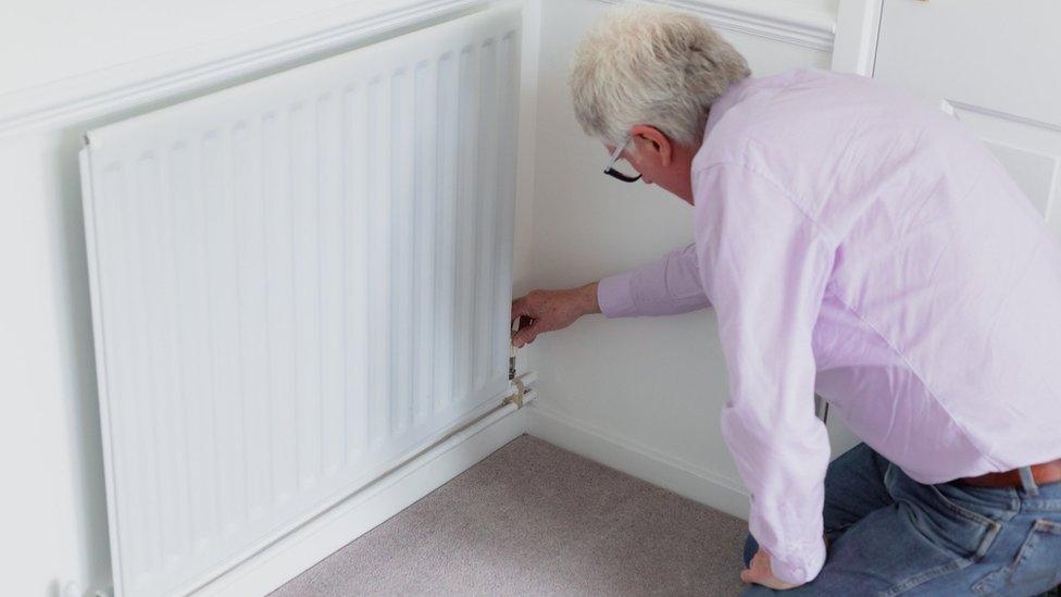 Man turning down radiator