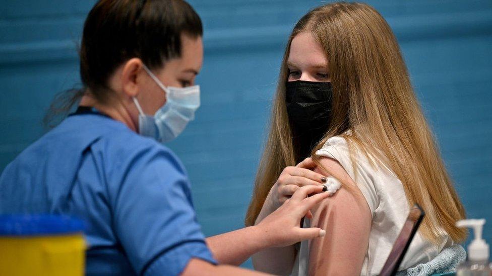 A teenager in Scotland getting a Covid jab