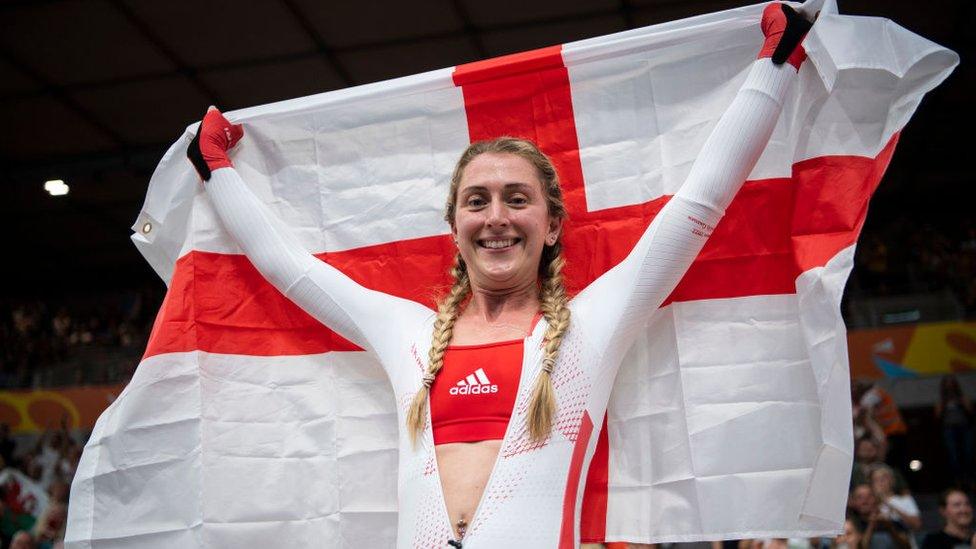 Laura Kenny of Team England celebrates with their flag after winning Gold in the Women's 10km Scratch Race on day four of the Birmingham 2022 Commonwealth Games.