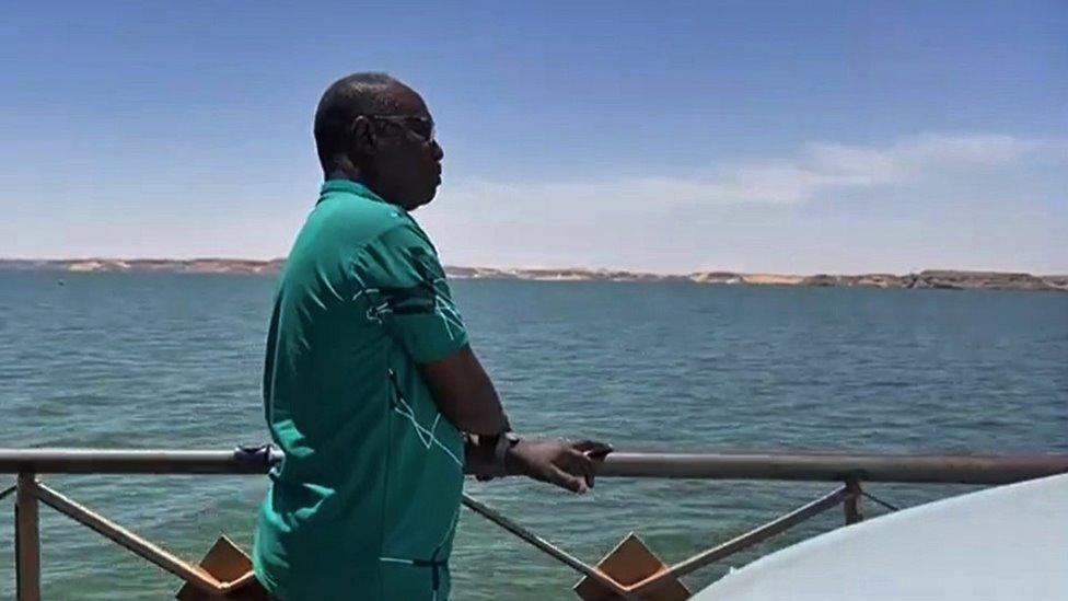 Mohamed Osman looks at the River Nile during the crossing between Sudan and Egypt