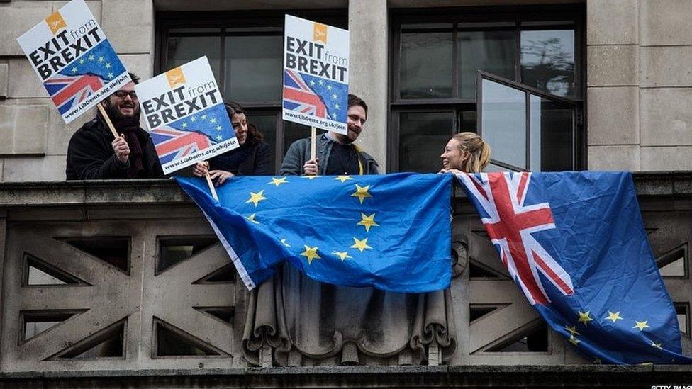 Lib Dem activists barrack Mr Johnson as he arrives for his speech