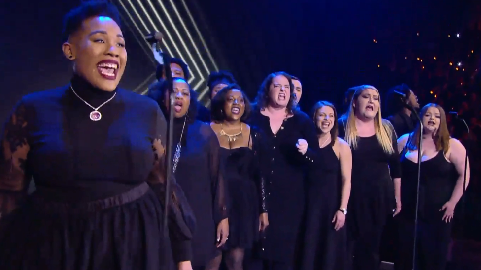 A choir performing at AEW Revolution