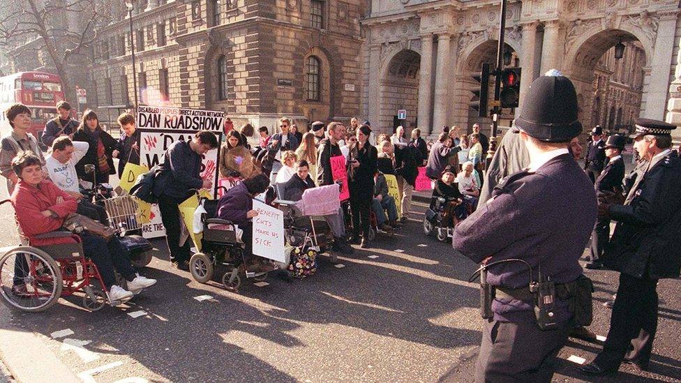 Protestors with policemen looking at them