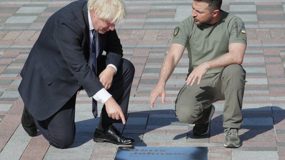 Ukrainian President Volodymyr Zelensky (R) and British Prime Minister Boris Johnson (L) attend the inauguration of a plate with Johnson"s name on the "Walk of the Brave", dedicated to politicians who support Ukraine amid the Russian invasion, in Kyiv, Ukraine, 24 August 2022