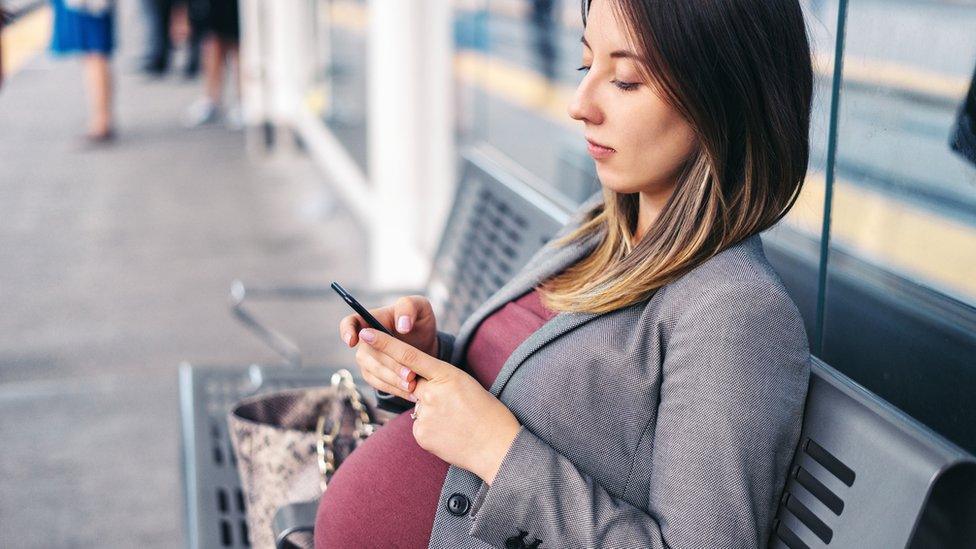 Pregnant woman sitting down