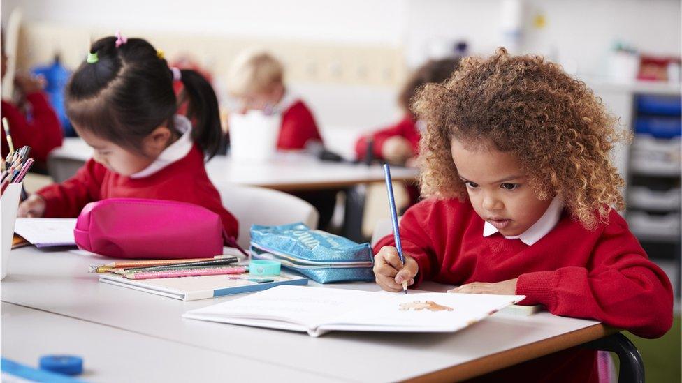 girls-writing-in-class.