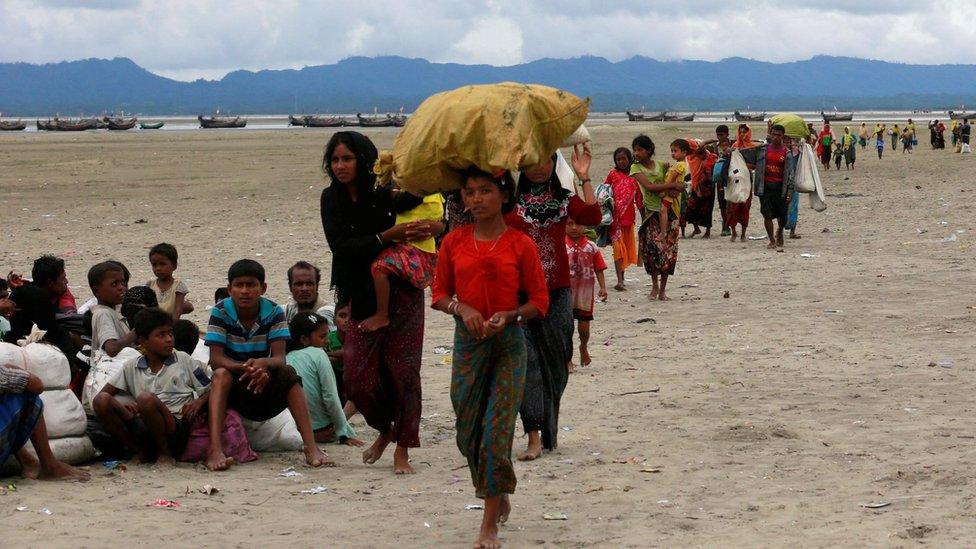 Rohingya refugees walk to a Border Guard Bangladesh (BGB) post after crossing the Bangladesh-Myanmar border by boat through the Bay of Bengal in Shah Porir Dwip, Bangladesh, 10 September 2017