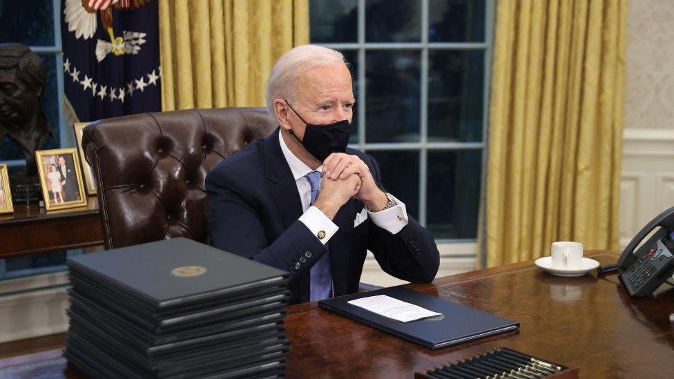 Mr Biden got to work straight away making changes to some of Mr Trump's policies. He sat at the famous desk in the Oval Office of the White House, the President's place of work.