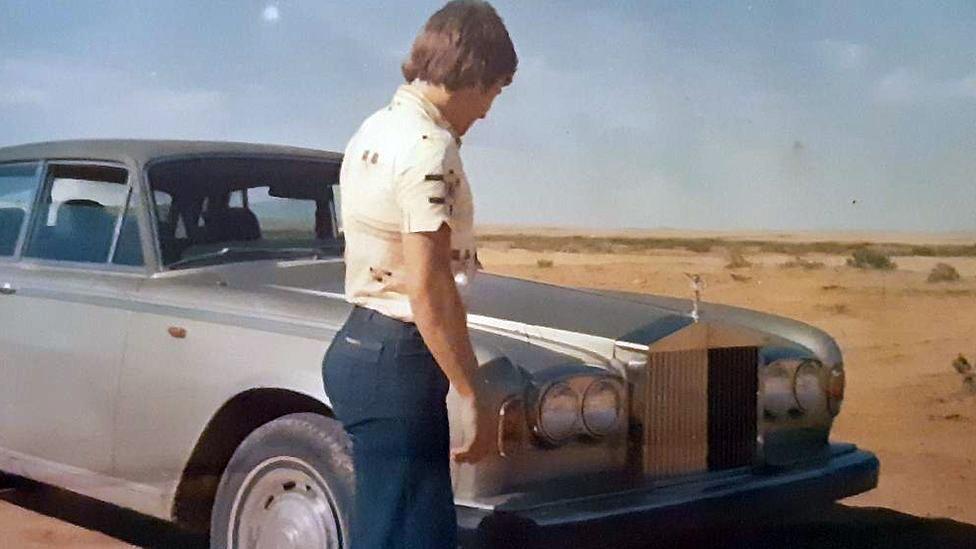 Eamonn with his car in the Saudi desert