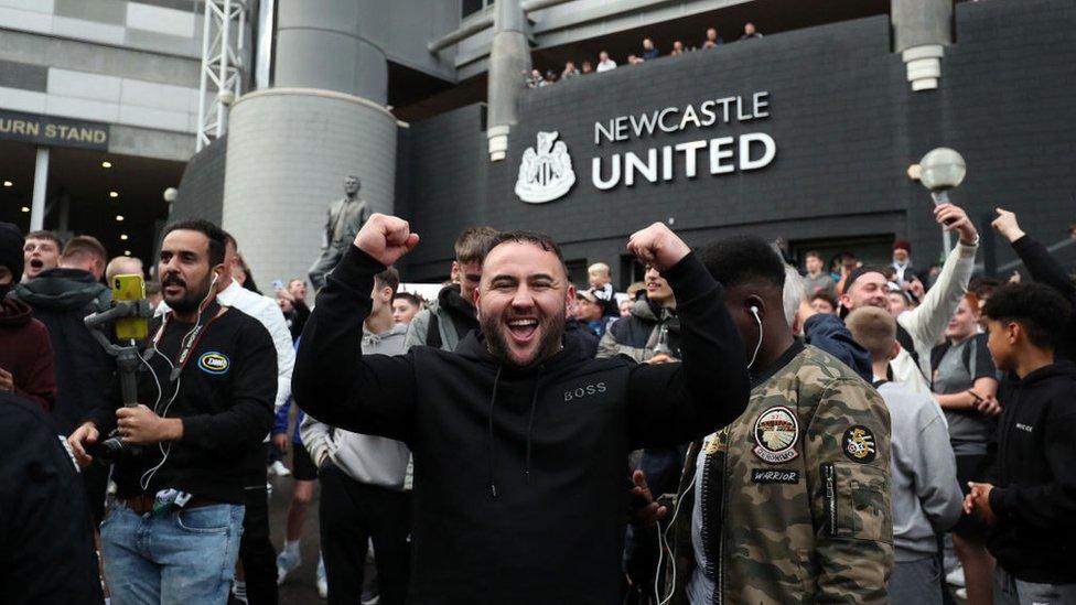 Newcastle fans celebrating at the club's stadium