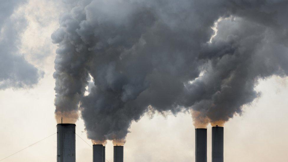 Factory chimneys releasing clouds of smoke