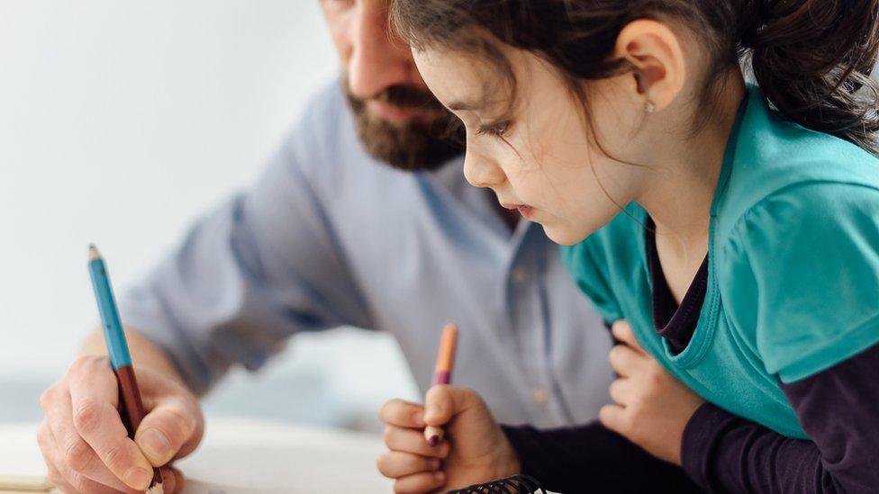 Parent helping child do homework