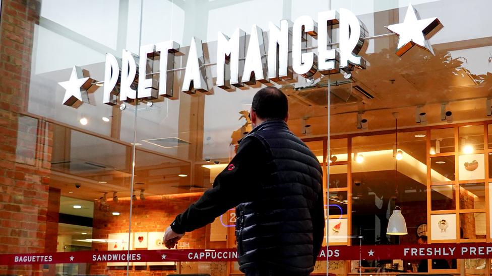 A man walks past a Pret a Manger