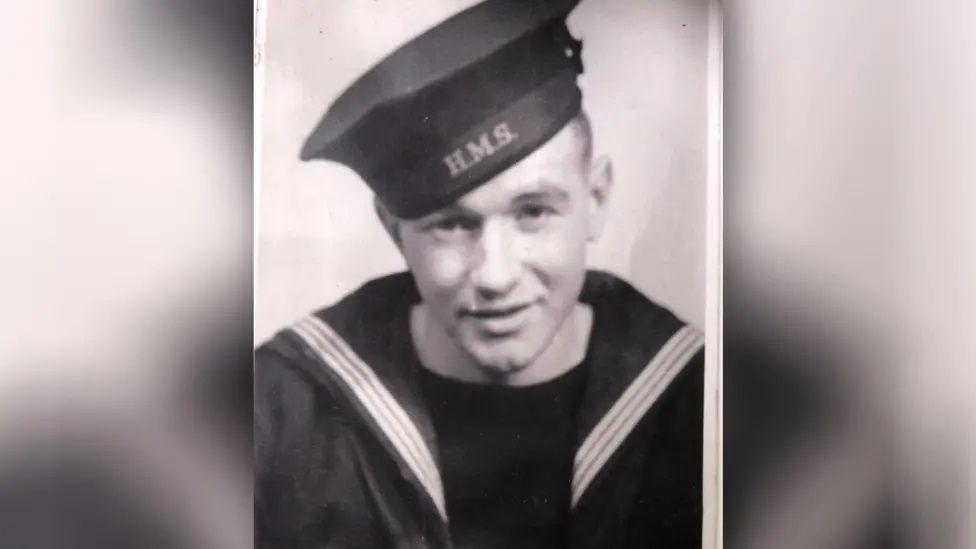 A black and white photo of a young Albert Keir in naval uniform