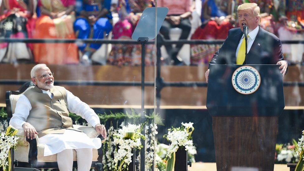 Donald Trump and Narendra Modi on stage during the US president's address