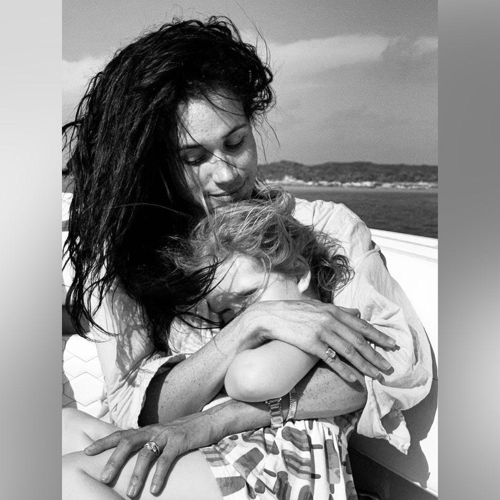 Meghan holding Lilibet in her arms