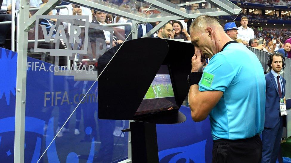 Referee Nestor Pitana reviews VAR footage before awarding France a penalty during the 2018 FIFA World Cup Final.