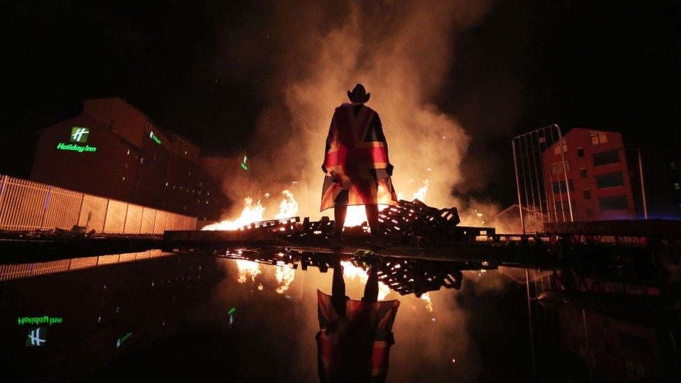 Man with flag at Belfast bonfire