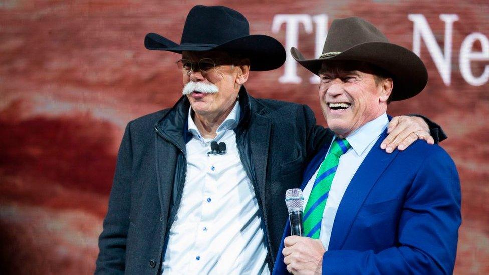 Dr. Dieter Zetsche (L), Chairman of the Management Board of Mercedes-Benz, speaks with actor and former California Governor Arnold Schwarzenegger during the unveiling of the new Mercedes G-Wagon