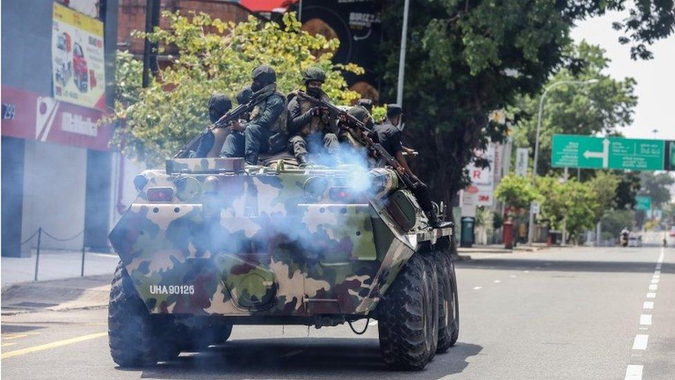 Armed military personnel patrol during an island-wide curfew amid political unrest in Colombo, Sri Lanka, 11 May 2022.