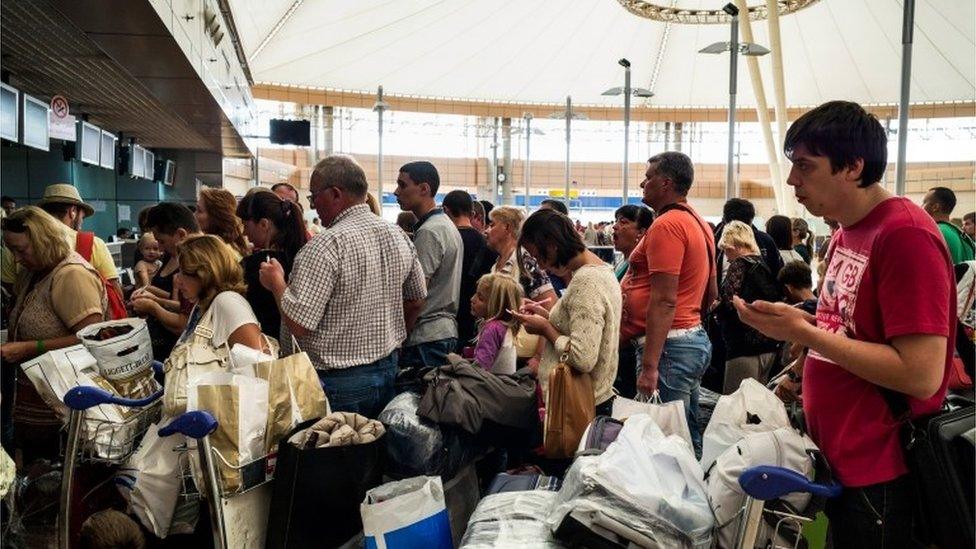 Passengers wait to check in for their flight out of Sharm El-Sheikh airport