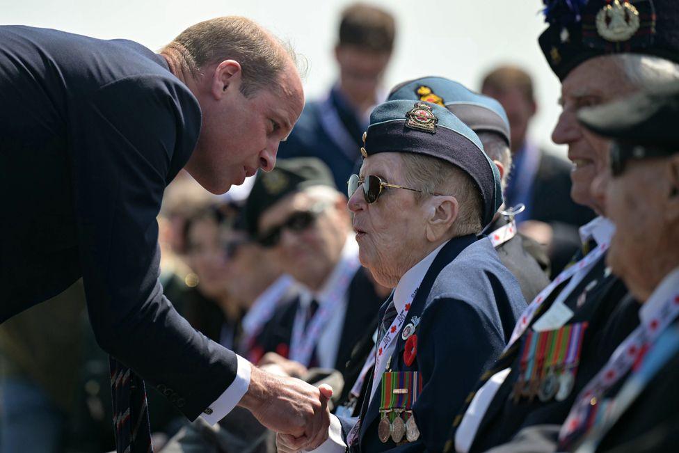 Britain's Prince William, the Prince of Wales, speaks with WWII veterans during the Canadian commemorative ceremony marking the 80th anniversary of the World War II 'D-Day' Allied landings in Normandy, at the Juno Beach Centre near the village of Courseulles-sur-Mer, in north western France, 06 June 2024.