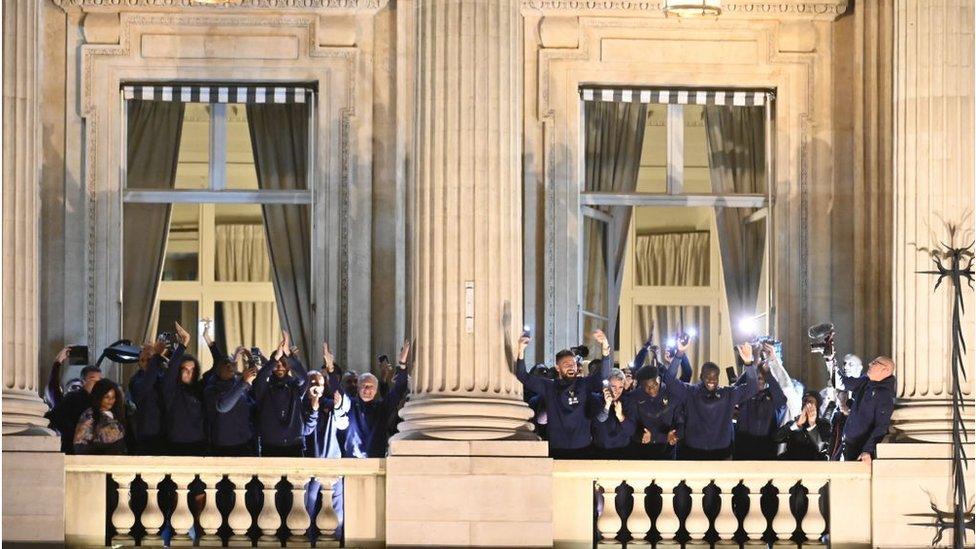 Members of France's World Cup football team cheer on a balcony