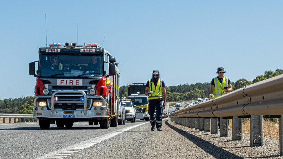 A handout image shows emergency workers in Australia searching for a radioactive capsule along a road