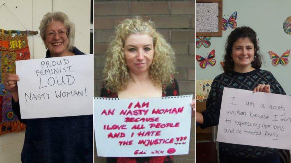 Three women holding banners explaining their support for Nasty Women