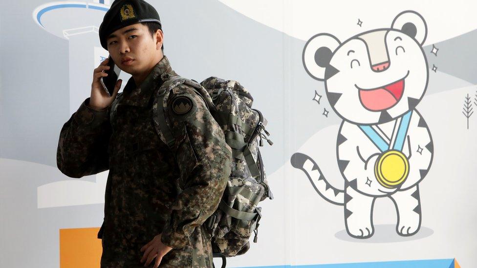 A South Korean soldier uses mobile phone at the 2018 PyeongChang Winter Olympic and Paralympic Games PR booth on January 5, 2018 in Seoul, South Korea