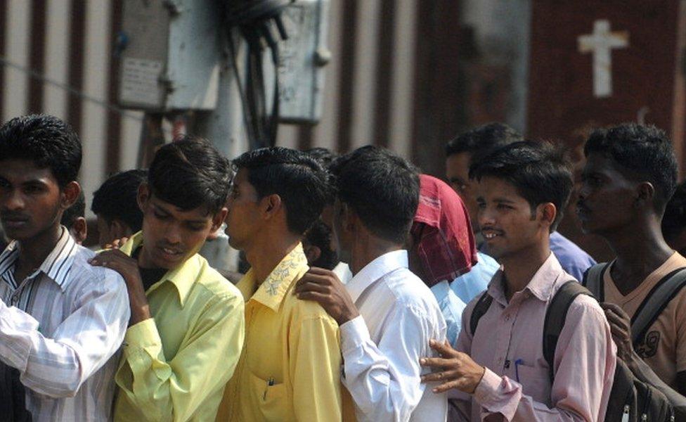 Indian youth queue at a jobs fair in Mumbai on October 12, 2011. C