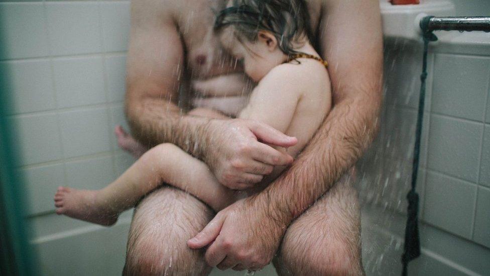 Thomas in the shower with his son Fox