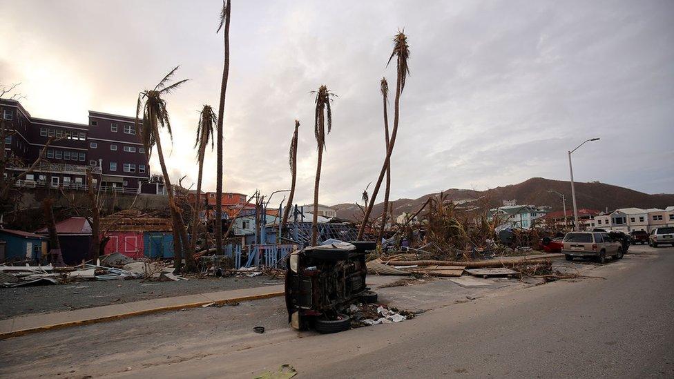 Damaged houses, felled trees and an overturned vehicle on British Virgin Islands