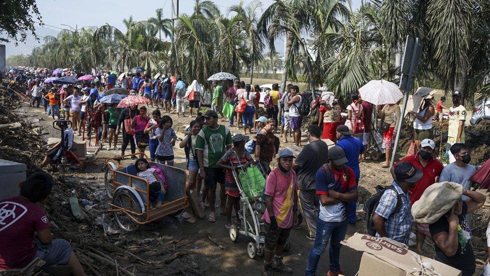 A group of people wait to receive food due to the shortage after Hurricane Otis in Guerrero, Mexico on October 29, 2023.