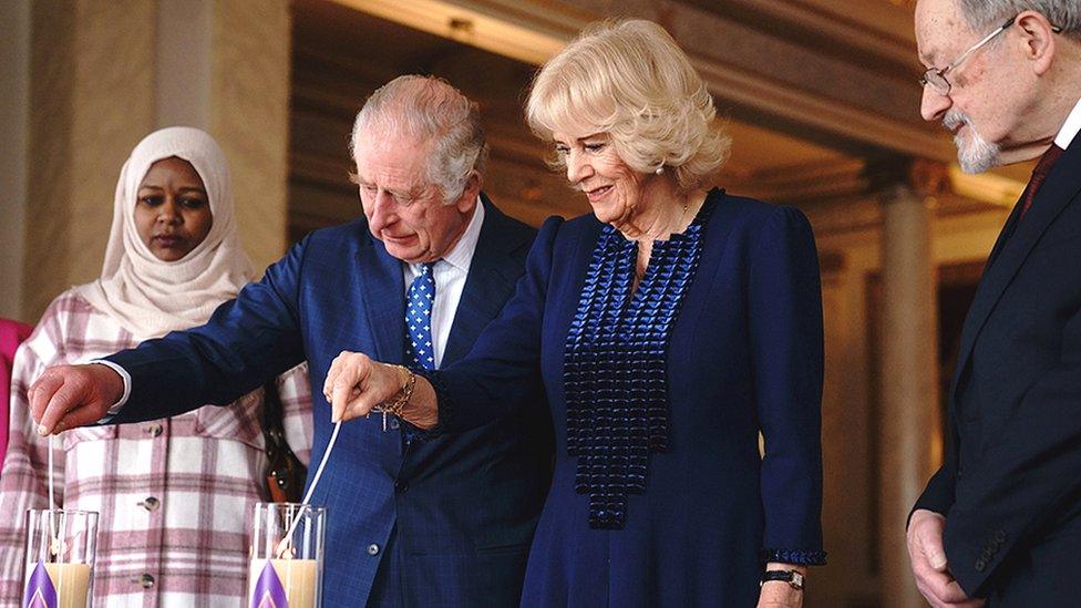 King Charles III and the Queen Consort light a candle at Buckingham Palace, London, to mark Holocaust Memorial Day, alongside Holocaust survivor Dr Martin Stern and a survivor of the Darfur genocide, Amouna Adam