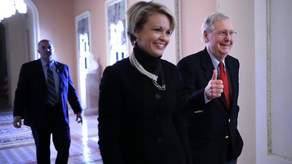 Senate Majority Leader Mitch McConnell (R-KY) gives a thumbs-up as he and his Director of Operations Stephanie Muchow head for the Senate floor at the U.S. Capitol December 1, 2017 in Washington, DC