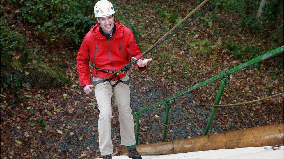 Prince William ascends a climbing wall as he visits the Towers Residential Outdoor Education Centre