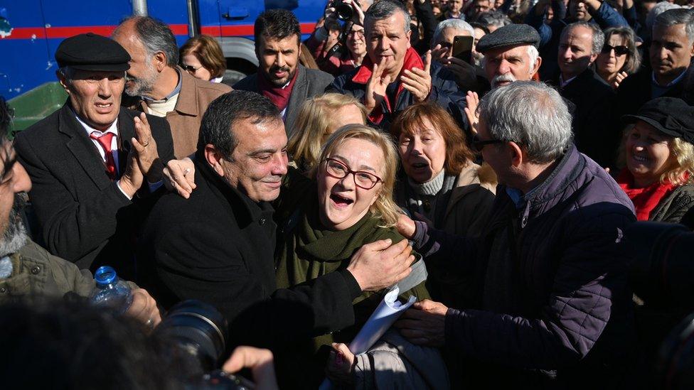 Supporters of the defendants celebrate after the verdict is announced