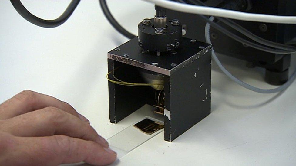 Loading a blood sample into the prototype detector for testing.